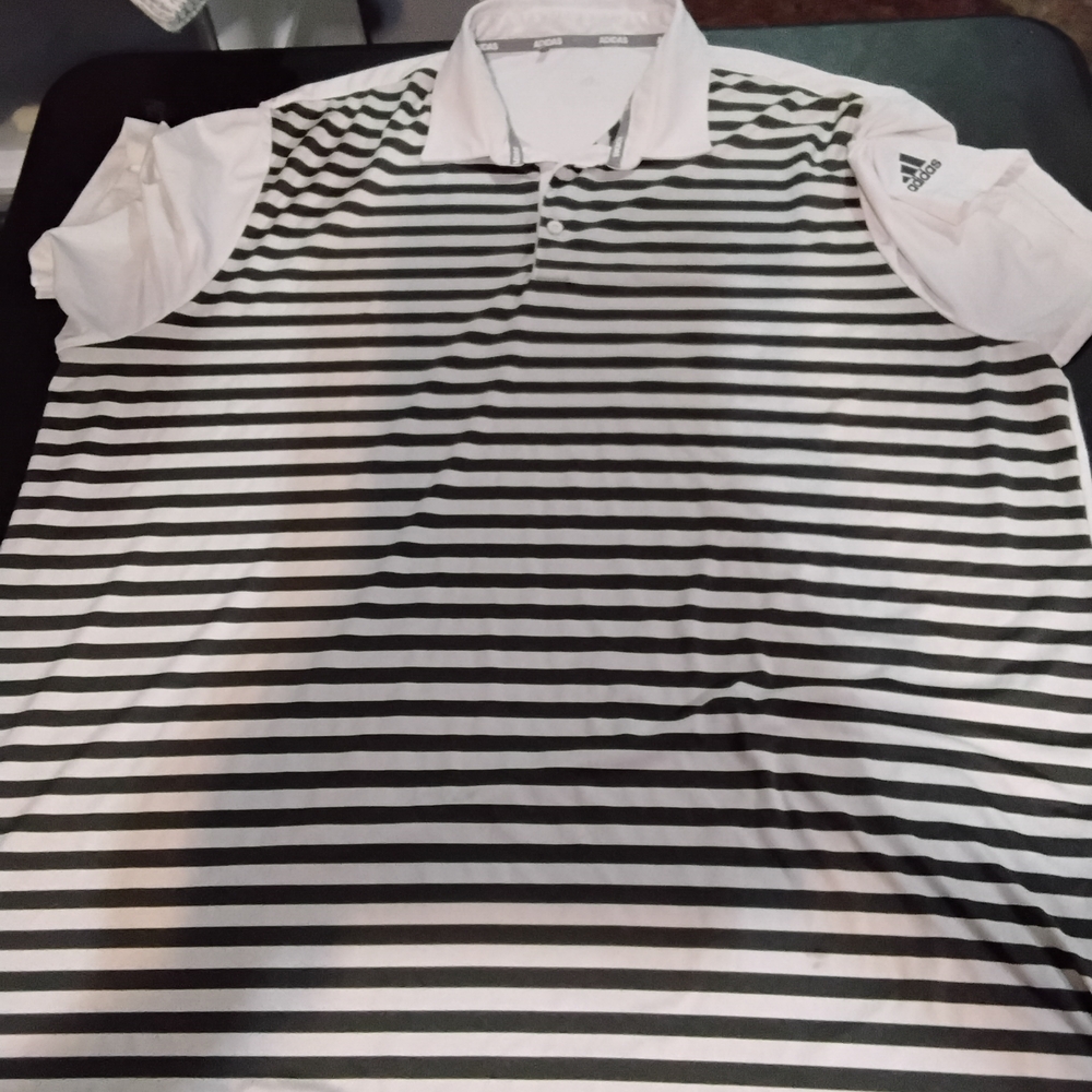 This is an Adidas men's performance golf polo shirt in a white and black